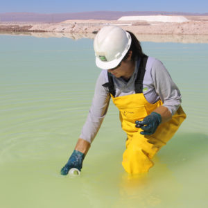 Lithium expert woman in yellow raincoat